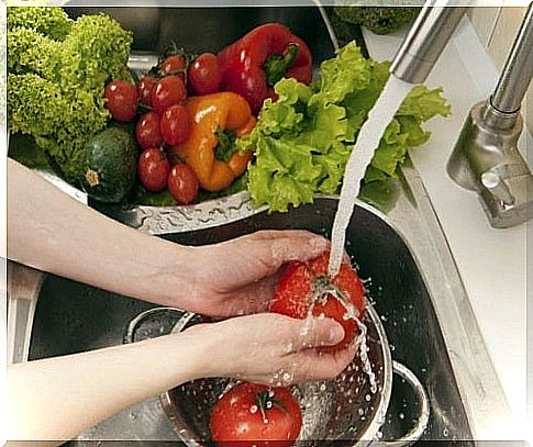 Woman washing vegetables