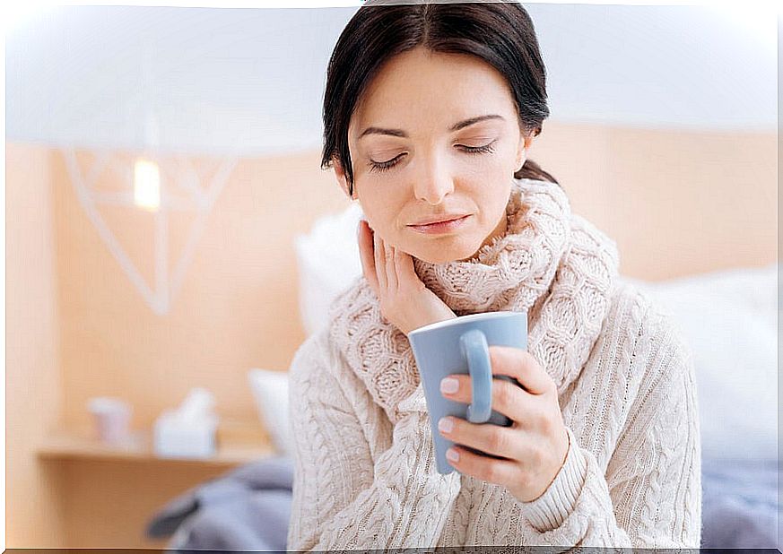 Woman with a scarf and a mug in her hand