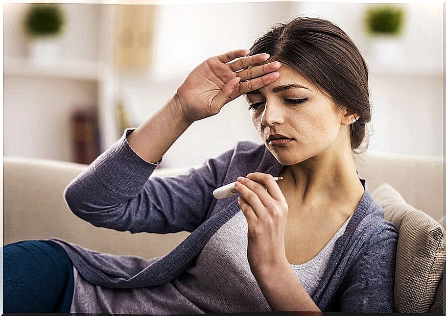 Woman lying with her hand on her forehead.