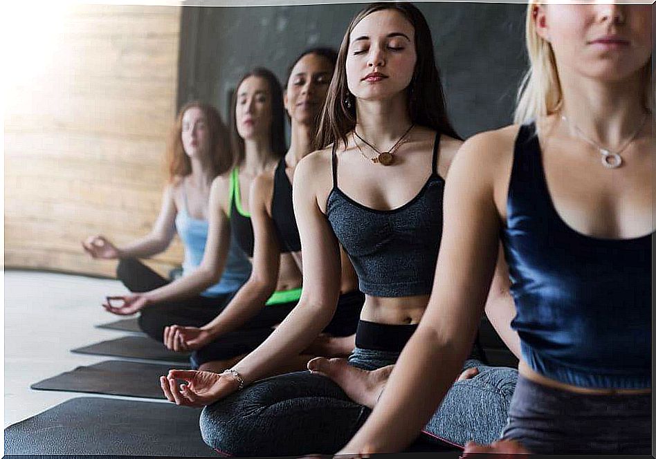 Women meditating in yoga class.