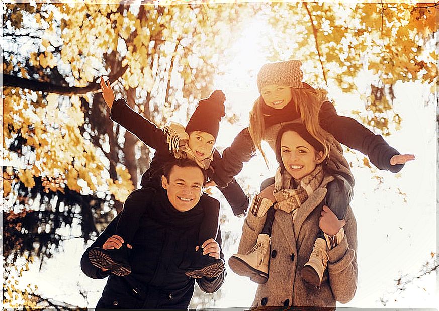 Family with children happily enjoy themselves in a park in autumn.