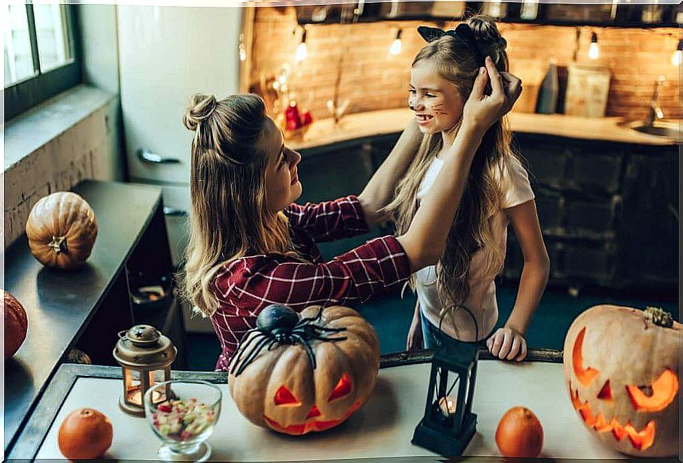 Mother disguising a girl on halloween