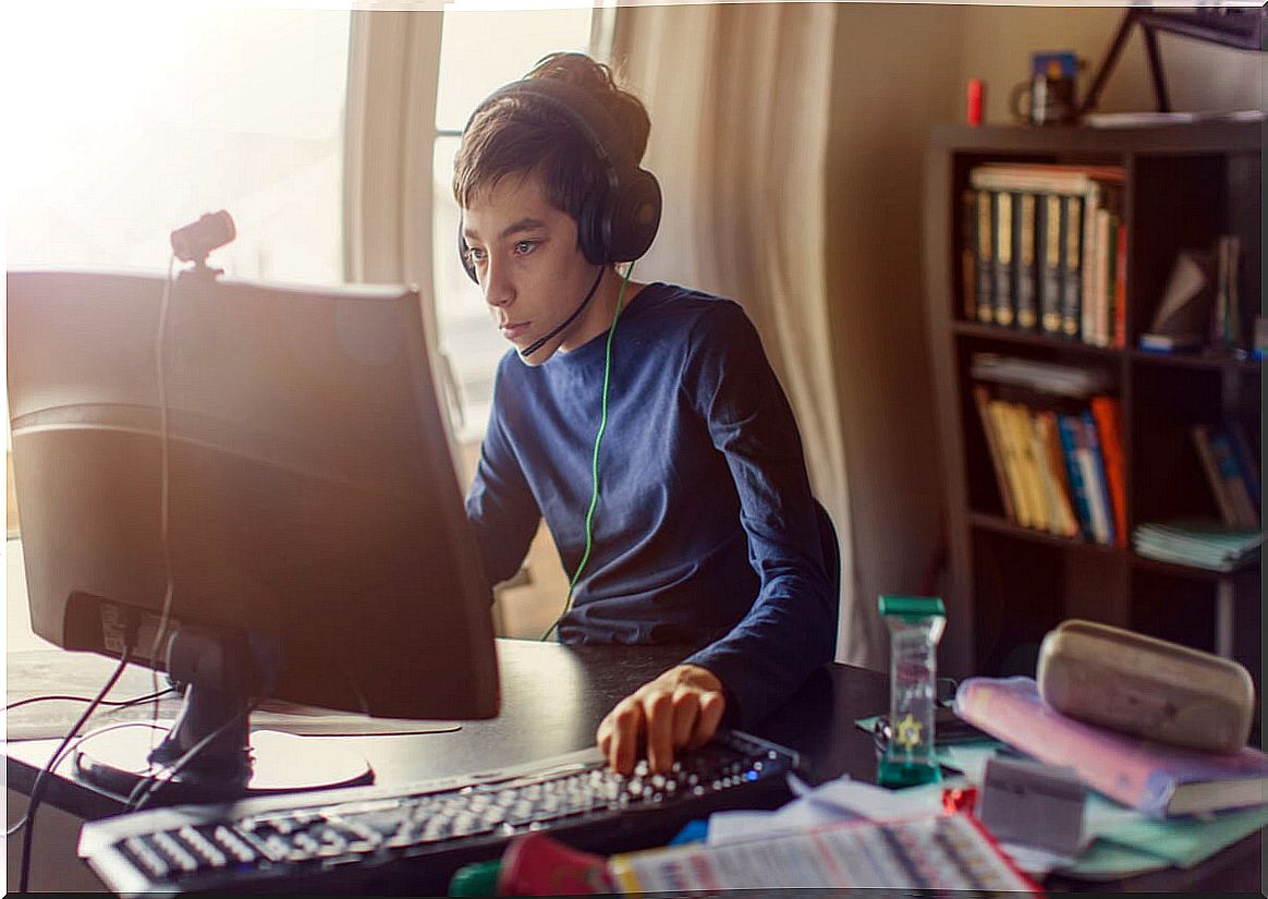 Young man in front of a screen watching video games.