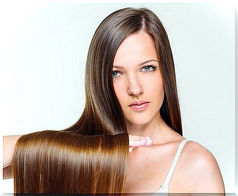 Woman with long and shiny straight hair thanks to the natural mask that has been applied