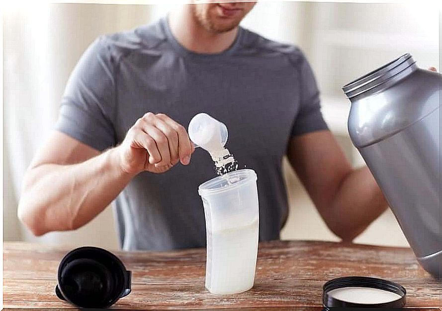 Man making himself a whey protein shake.